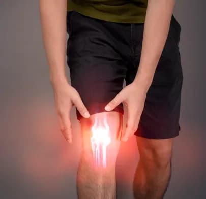 Person clutching painful knee with digital overlay, illustrating injury linked to ACL Reconstruction in India.