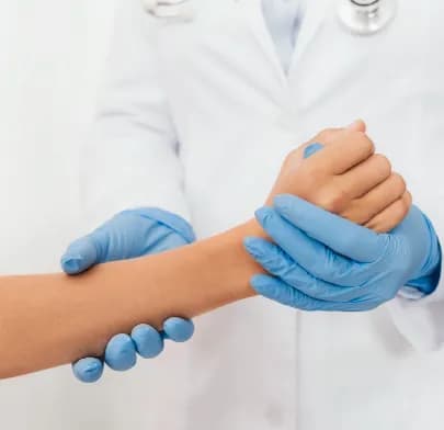 Doctor examines patient’s wrist, illustrating care related to Hand and Wrist Surgery in India